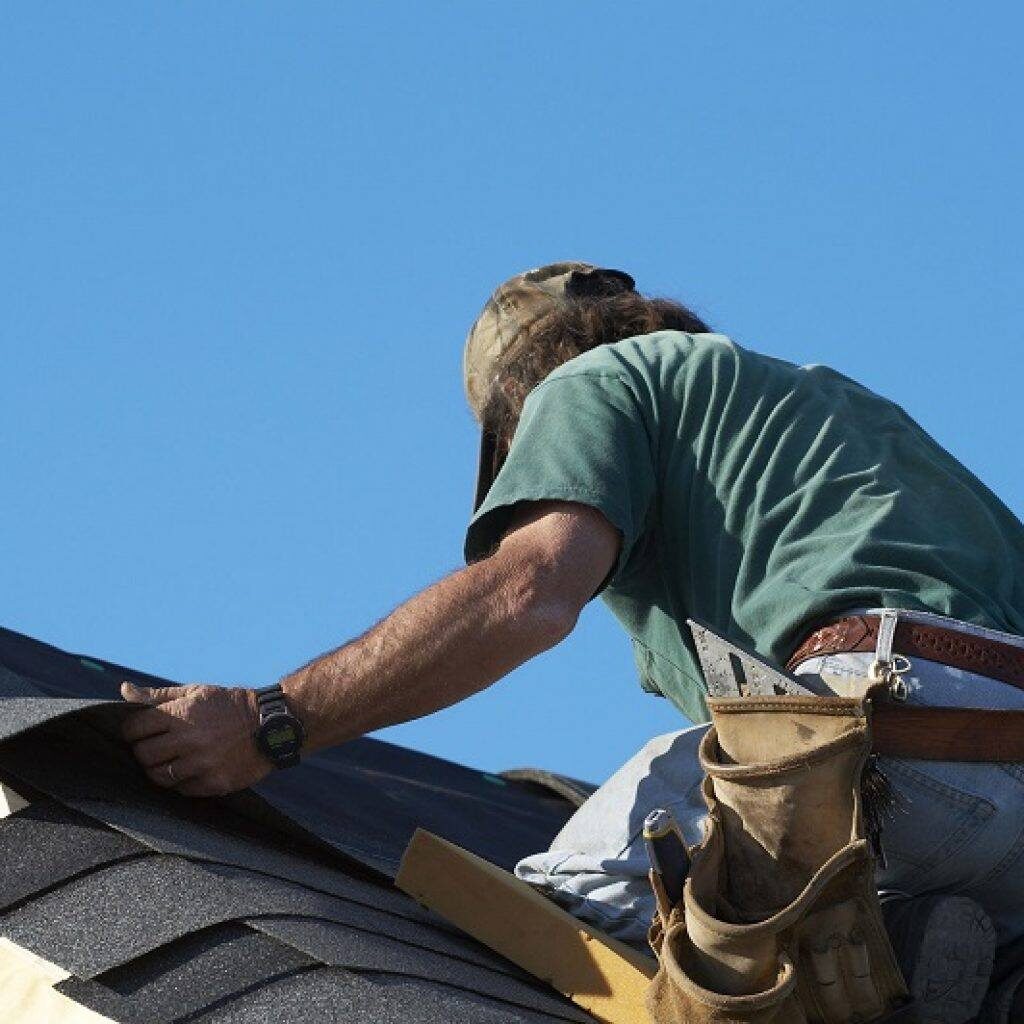 At The Top Roofing Expert Working on Roof
